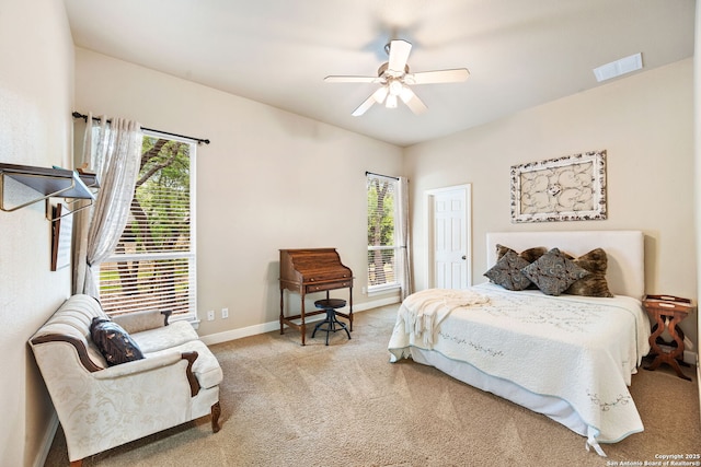 carpeted bedroom featuring baseboards, visible vents, and ceiling fan