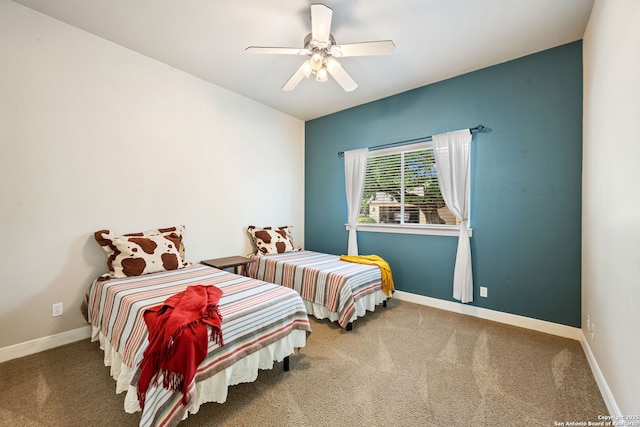 carpeted bedroom with baseboards and ceiling fan