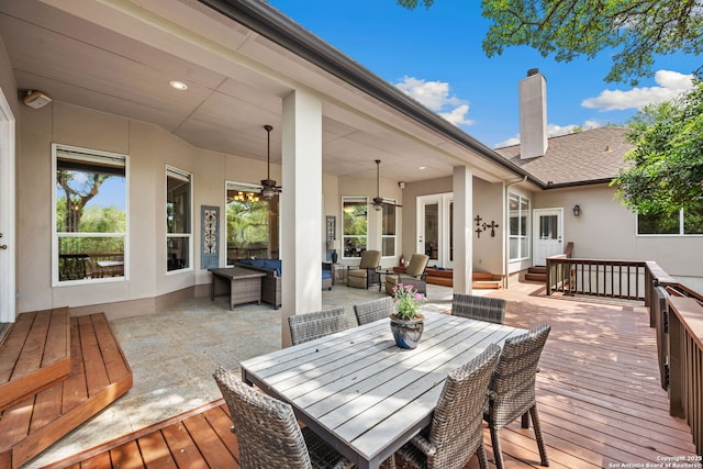 wooden deck with french doors, a ceiling fan, and an outdoor hangout area