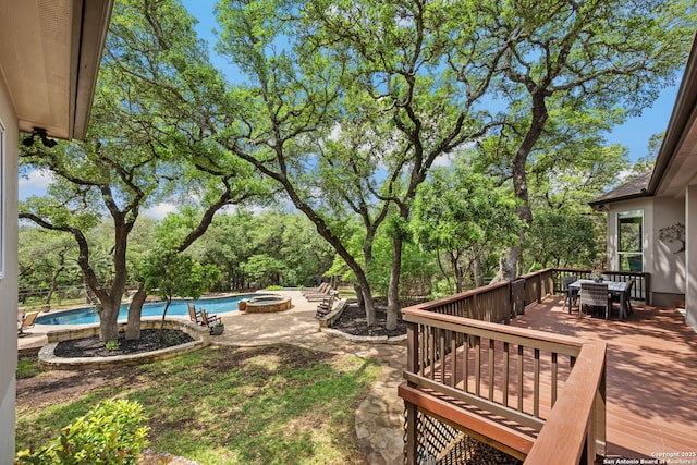 view of yard with an outdoor pool, a deck, and outdoor dining area