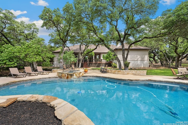 view of swimming pool featuring a pool with connected hot tub and a patio area