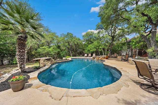 outdoor pool with a patio area