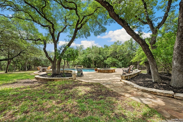 view of yard with an outdoor pool, an outdoor fire pit, and a patio
