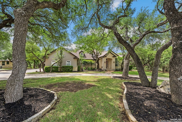 view of front of home with stucco siding and a front yard