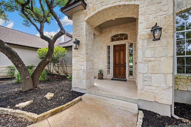 doorway to property with stone siding