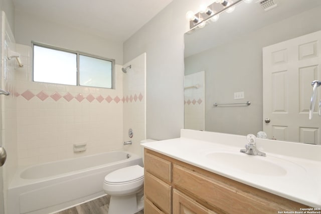 6530 Lochglen, San Antonio, TX 78240 - bathroom featuring visible vents, toilet, bathing tub / shower combination, wood finished floors, and vanity