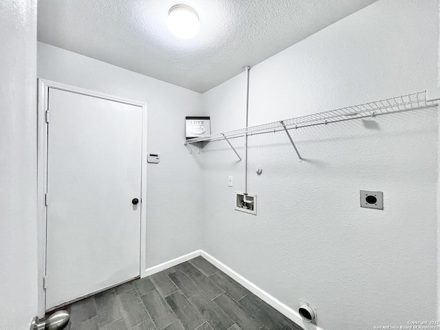 washroom featuring washer hookup, electric dryer hookup, baseboards, wood finish floors, and laundry area
