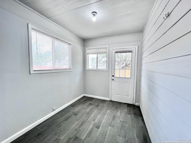 doorway to outside featuring dark wood-style floors and baseboards