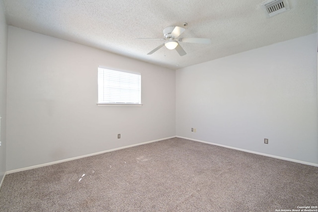 carpeted empty room featuring baseboards, visible vents, a ceiling fan, and a textured ceiling