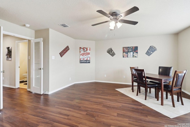 dining room featuring ceiling fan, wood finished floors, visible vents, baseboards, and french doors