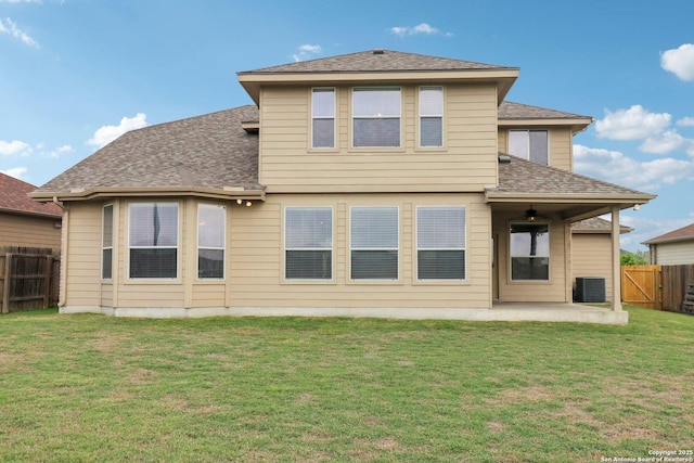 back of house with a patio, roof with shingles, a yard, central AC, and a fenced backyard