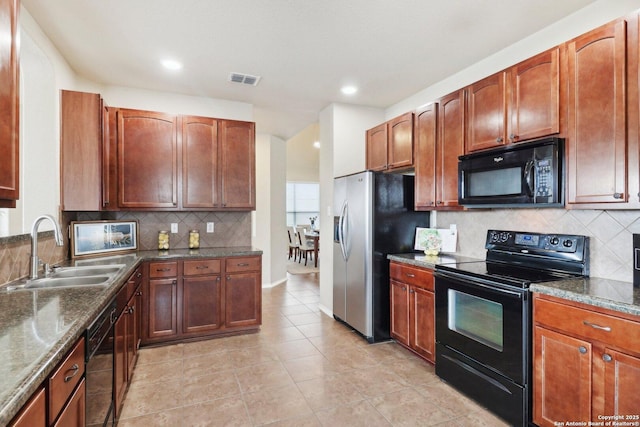 kitchen featuring a sink, light tile patterned floors, black appliances, visible vents, and backsplash