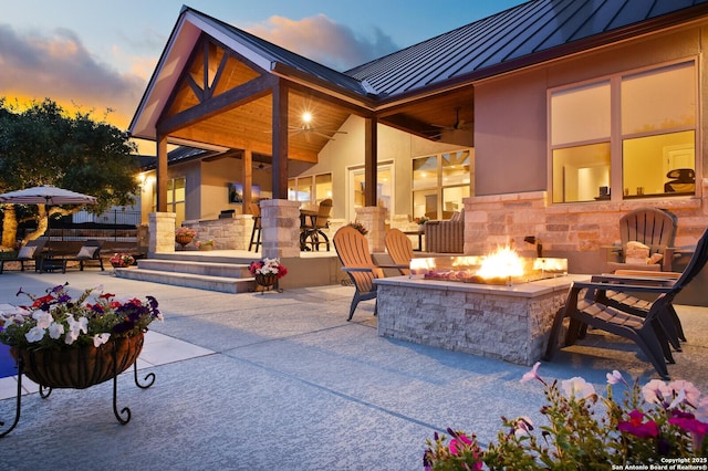 view of patio featuring an outdoor fire pit and ceiling fan