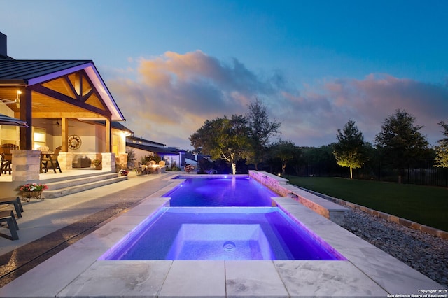 pool featuring a lawn, an in ground hot tub, and a patio area