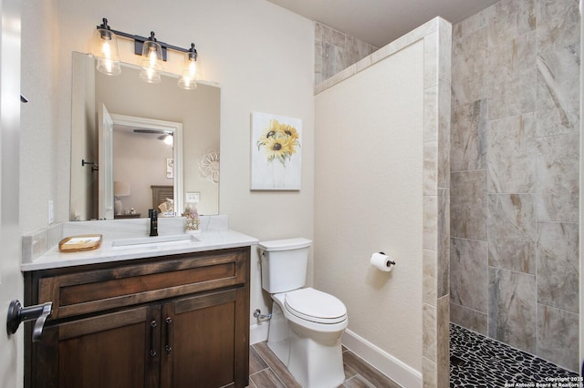 full bathroom featuring a walk in shower, toilet, vanity, baseboards, and wood tiled floor