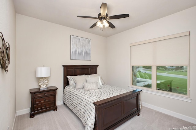 bedroom with baseboards, light carpet, and ceiling fan