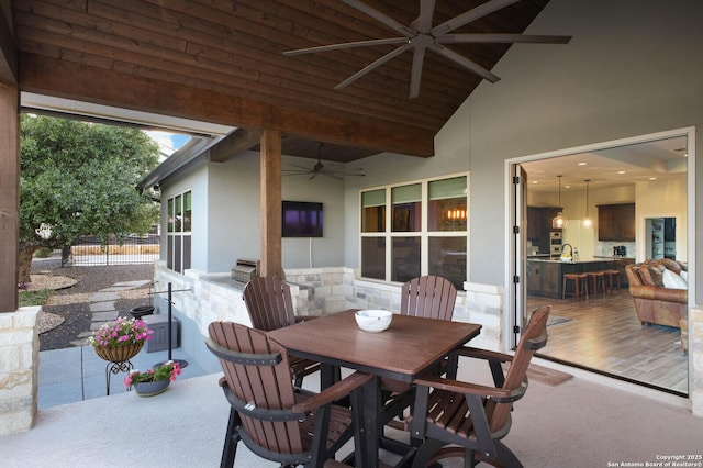 view of patio / terrace with fence, outdoor dining space, and a ceiling fan