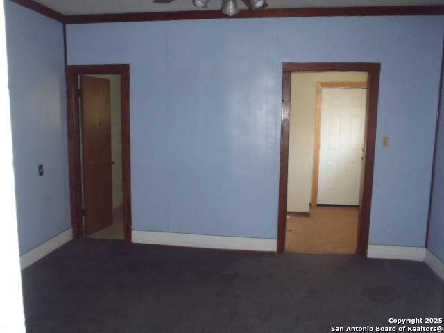 carpeted spare room featuring baseboards
