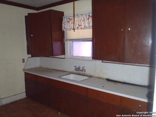 kitchen with light countertops and a sink