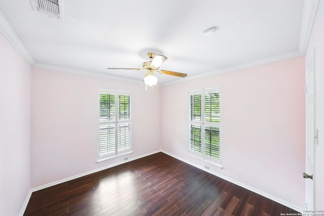 empty room featuring a ceiling fan, dark wood-type flooring, and plenty of natural light