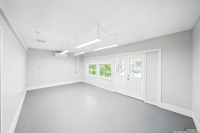 interior space featuring visible vents, finished concrete floors, and baseboards
