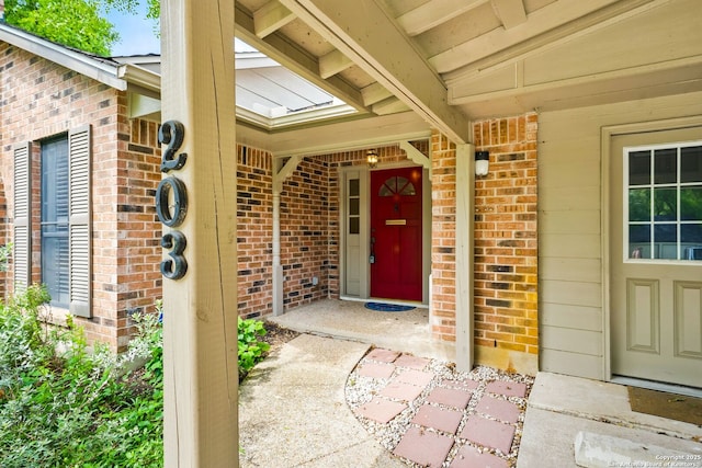 property entrance featuring brick siding