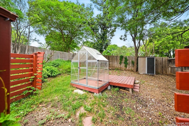 view of yard with an exterior structure, an outbuilding, and a fenced backyard