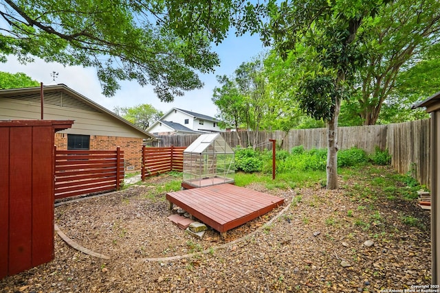 view of yard with an outdoor structure, an exterior structure, and a fenced backyard