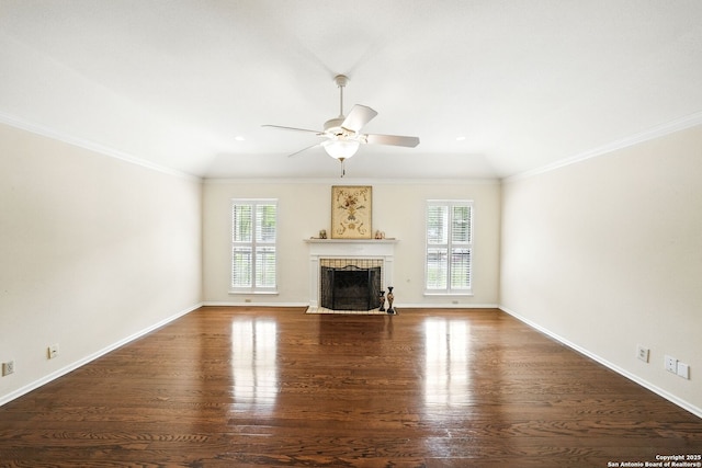 unfurnished living room with a brick fireplace, wood finished floors, lofted ceiling, and plenty of natural light