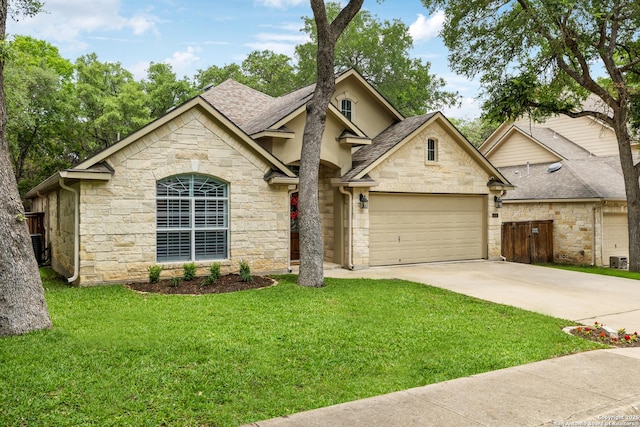 view of front of property with roof with shingles, driveway, an attached garage, and stone siding