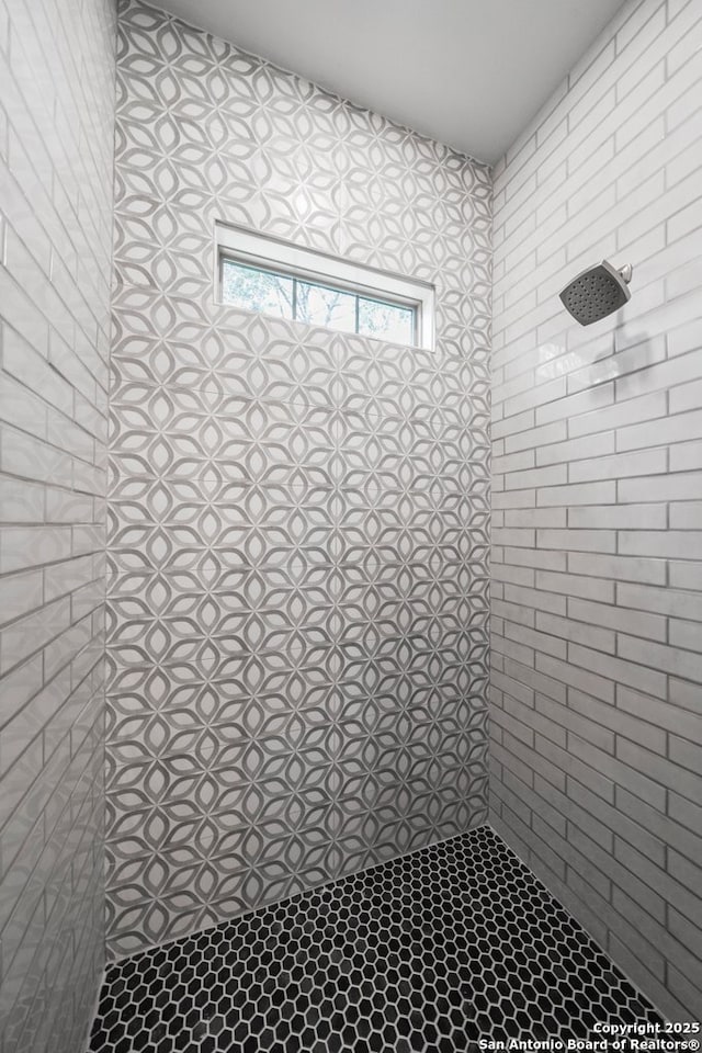 bathroom with a tile shower