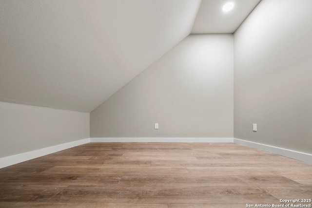 bonus room featuring recessed lighting, wood finished floors, lofted ceiling, and baseboards