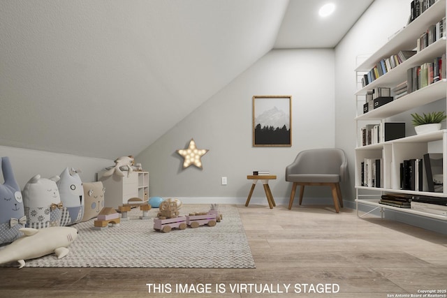 bedroom featuring wood finished floors and vaulted ceiling