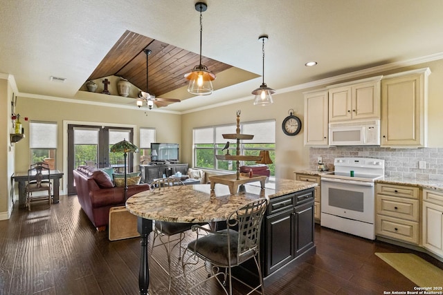 kitchen with dark wood-style floors, cream cabinets, white appliances, open floor plan, and plenty of natural light