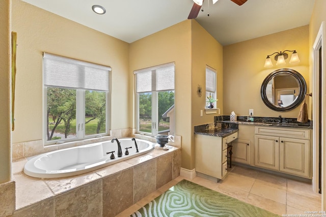 full bath featuring a ceiling fan, a garden tub, tile patterned flooring, and vanity