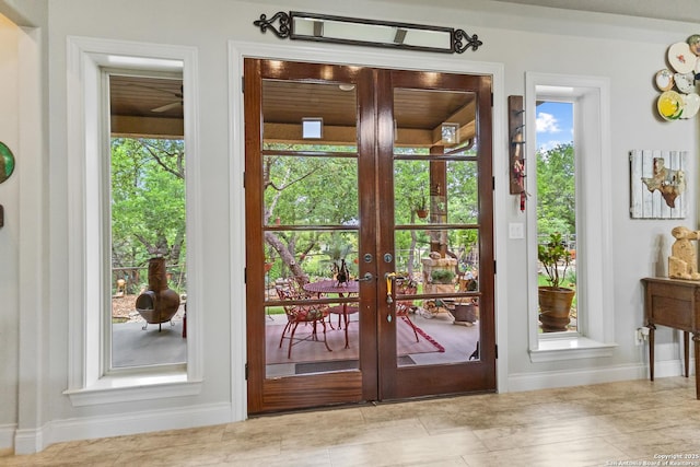 doorway to outside with a wealth of natural light, french doors, and baseboards
