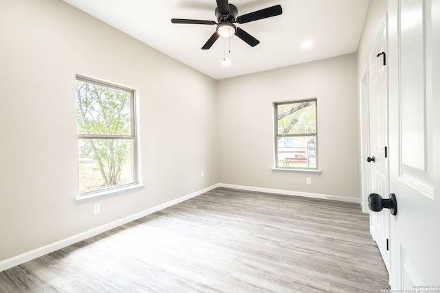 908 Plum, Floresville, TX 78114 - unfurnished bedroom featuring a closet, light wood-type flooring, baseboards, and multiple windows