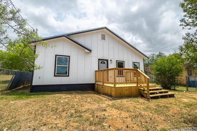 908 Plum, Floresville, TX 78114 - back of house featuring a lawn, a wooden deck, and fence