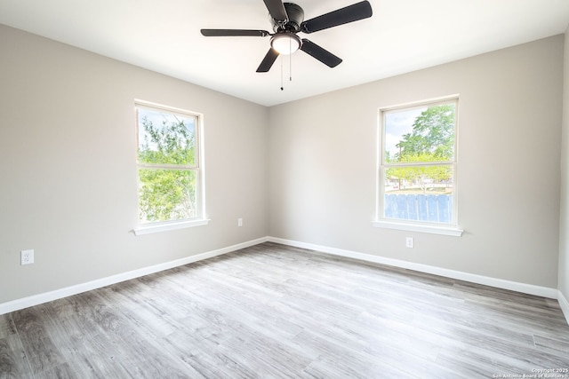 908 Plum, Floresville, TX 78114 - empty room with baseboards, wood finished floors, ceiling fan, and plenty of natural light