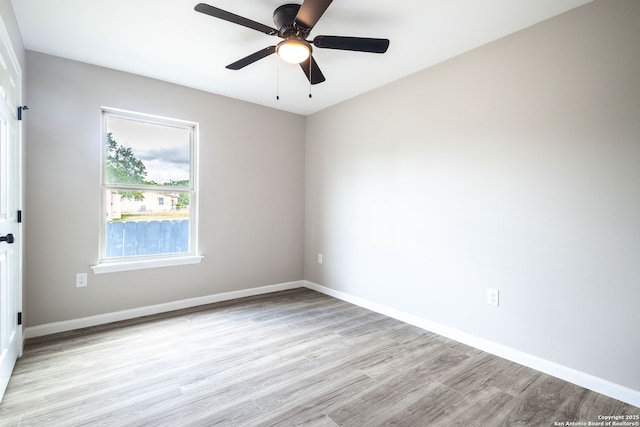 908 Plum, Floresville, TX 78114 - spare room featuring ceiling fan, light wood-type flooring, and baseboards