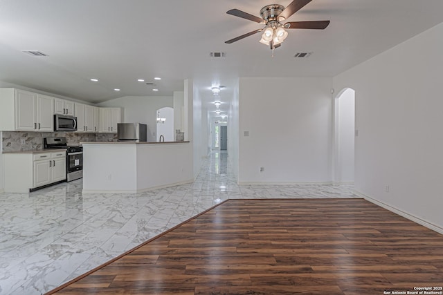 unfurnished living room with recessed lighting, a ceiling fan, visible vents, arched walkways, and lofted ceiling