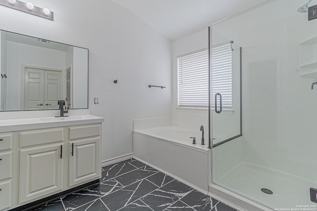 bathroom with a stall shower, baseboards, a garden tub, vanity, and marble finish floor