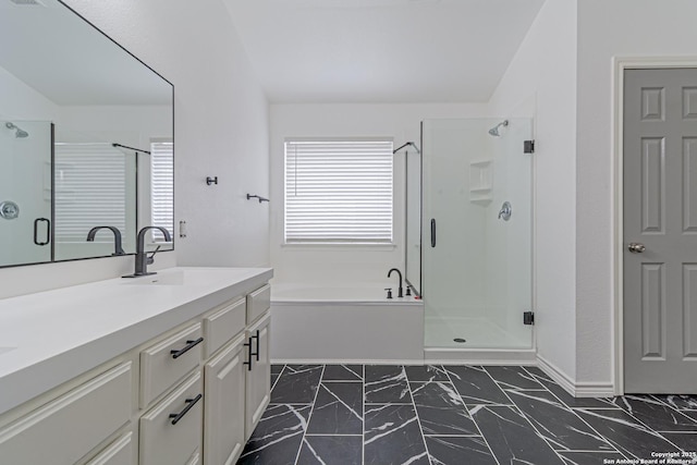 bathroom featuring vanity, a stall shower, marble finish floor, baseboards, and a garden tub