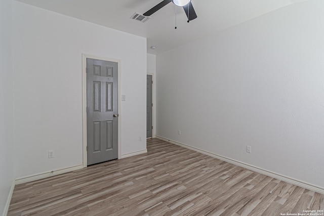 spare room with visible vents, ceiling fan, baseboards, and light wood-style floors