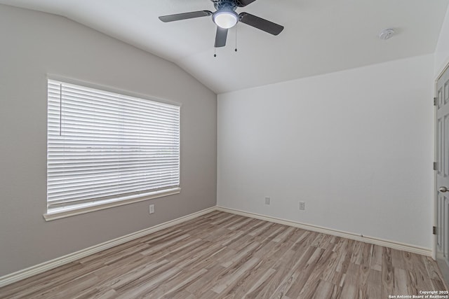 spare room with baseboards, light wood-type flooring, ceiling fan, and vaulted ceiling