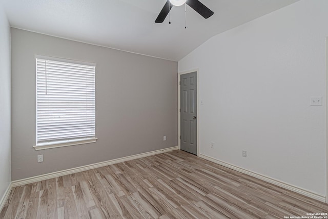 unfurnished room with light wood-style floors, ceiling fan, vaulted ceiling, and baseboards