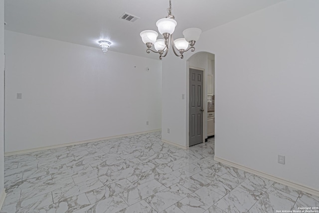 unfurnished room with a notable chandelier, marble finish floor, visible vents, baseboards, and arched walkways
