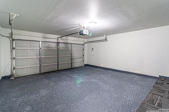 garage with baseboards and a garage door opener