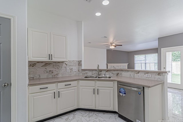 kitchen featuring marble finish floor, dishwasher, a sink, a ceiling fan, and a peninsula