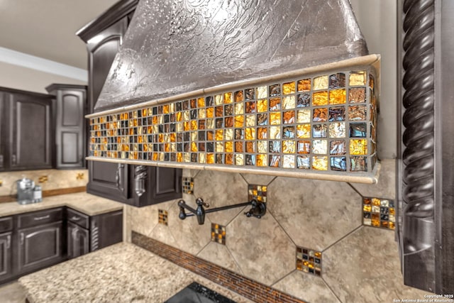interior space featuring dark brown cabinetry, backsplash, and light countertops
